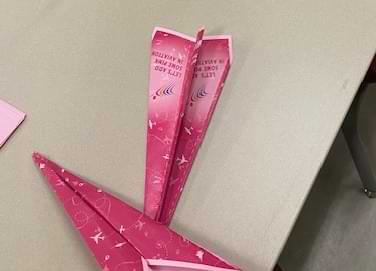 pink paper airplanes