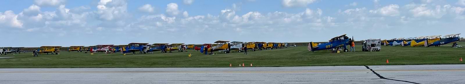 line up of Stearman biplanes